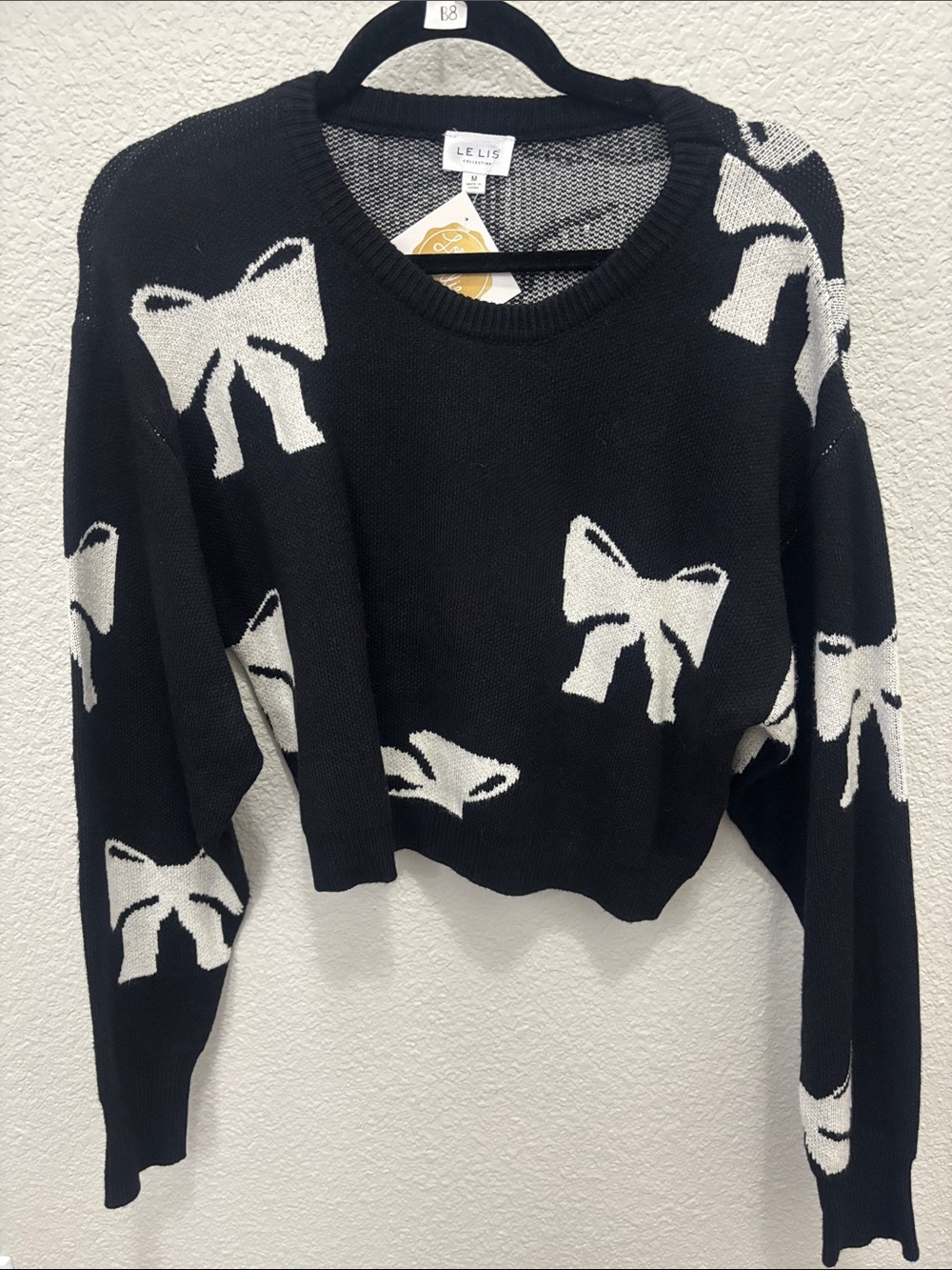 Le Lis Black Crewneck Sweater with White Bow Motif